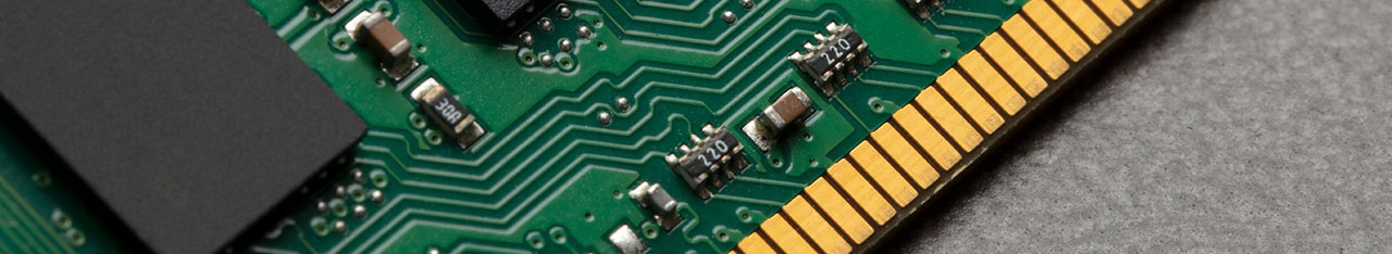  Close up partial view of a RAM, showing gold fingers, memory chips, PCB, resistors, and tracing.  